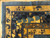 Corner detail of woven pavilions, butterflies and tan outer border on hand-knotted Chinese wool rug