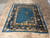 7'3" x 8'11" antique Chinese rug photographed on travertine tile from the opposite end