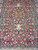 5x7 Persian Isfahan design rug detail showing mirrored floral panels, navy ground and flowering border