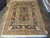 9'3" x 11'10" hand-knotted wool rug from India laid out on a showroom tile floor