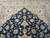 Ivory spandrels meeting the navy field, camel palmettes and silk outlined flowering vines
