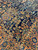 Corner where navy field meets rust border with olive leaves, orange blossoms and ivory guard stripe