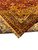 Folded corner showing gold fringe, layered border stripes and the original selvage finish