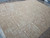 Angled floor view showing the low profile flat weave surface and soft camel ground
