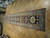 Long antique wool runner laid on parquet flooring, teal border and ivory diamond medallions visible