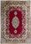 Full overhead view of 10 x 13 Persian Kerman rug, red field, navy medallion, ivory border