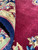 Folded pile close-up showing plush wool surface, deep red nap and navy selvage edge