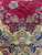 Detail of red field meeting navy border with green cartouche, roses and gold acanthus scrolls