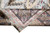 Folded corner reveals fine hand-knotted silk weave, dark paisley border and natural silk fringe
