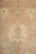 Large ivory palmette flanked by pale blue tendrils on the warm earth toned Peshawar field