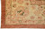 Border corner detail with green palmette, coral vine work and plain rust outer stripe