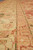 Close view along the ivory main border and slim green guard stripes running lengthwise