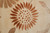 Copper sunflower with dotted seed head and pointed petals rendered in high sheen silk