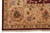 Corner detail of the camel border with rust palmettes, guard stripes and ivory fringe