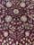 Macro of floral sprays and an 8 petal rosette woven in navy, gold and ivory