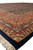 Side angle capturing ivory fringe, navy outer edge and richly drawn rust paisley borders