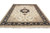 8'6" x 11'8" Tabriz design rug photographed at an angle showing ivory field and black border