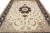 Close overhead detail of ivory field, sage green spandrels and black star medallion drawing