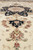 Center medallion close-up with pendant palmette, rose rosettes and sage leaves on ivory field