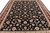 Close overhead detail of cream palmettes and scrolling vines across the inky black all-over field