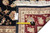 9 x 12 rug back with dealer tag F-4352 and tape measure against the burgundy border