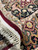 Folded corner revealing cotton foundation, tight hand-knotted weave and hand-tied ivory fringe
