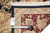 Back of the rug with tag reading 8.7 x 11.8 beside a tape measure