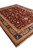Diagonal perspective of the large wool area rug showing ivory fringe and layered floral borders