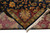 Rug folded back to reveal tight even knotting, cotton foundation and hand-tied ivory fringe