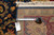 Back tag and tape measure confirming 10 x 14 genuine hand woven Oriental rug specifications