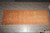 Overhead photo of the long hand-knotted wool runner laid flat on grey tile showroom floor
