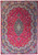 Crimson red Persian Mashad rug with navy lobed medallion and ivory floral border, full overhead view