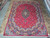 9'3" x 12'6" Mashad wool rug photographed flat on gallery stone floor showing full design