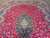Navy floral medallion and pendant on crimson field of hand-knotted Persian wool area rug