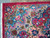 Corner detail showing turquoise, salmon and pink border scrollwork with original selvedge and ivory fringe