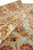Rolled edge detail of the soft wool pile, ivory border vinework and pale blue ground