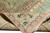 Rolled corner showing reverse side with crisp green palmette border and soft blush guard band