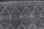Close-up of tonal diamond lattice motifs woven in indigo, slate and pale grey wool