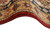 Curled edge view of the hand-wrapped red selvedge and amber border of this wool rug