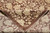 Folded back corner revealing hand-knotted weave, cotton foundation edge and the beige on brown pattern