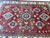Overhead detail of six diamond medallions and blue rosettes surrounding the star shaped center motif