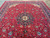 Room size 10x14 Persian rug photographed at an angle showing medallion and floral field symmetry