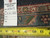 Back of rug with inventory tag reading 9.10 x 14.2 and tape measure across knots
