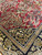 Detail of red field meeting navy animal border with gold vinework and small birds
