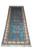 Angled length view showing teal silk field and scrolling ivory main border with navy guards
