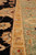 Detail of sage green outer border with gold guard stripe and scrolling vine work