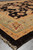 Angled corner view of 6' x 17'7" wide runner showing gold border and black field
