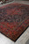 9'10" x 12'9" Persian rug corner view with wide red border and navy guard stripes