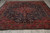 10x13 Persian Tabriz rug photographed from one end showing ivory fringe and red border