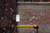 9'10" x 12'9" rug back with tape measure and dealer tag confirming the size